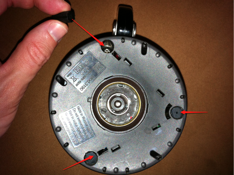 Remove rubber plugs to get to the screws